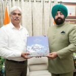 Photographer Bhumesh Bharti met the Governor and presented him the coffee table book 'Aerial Vistas of Uttarakhand'