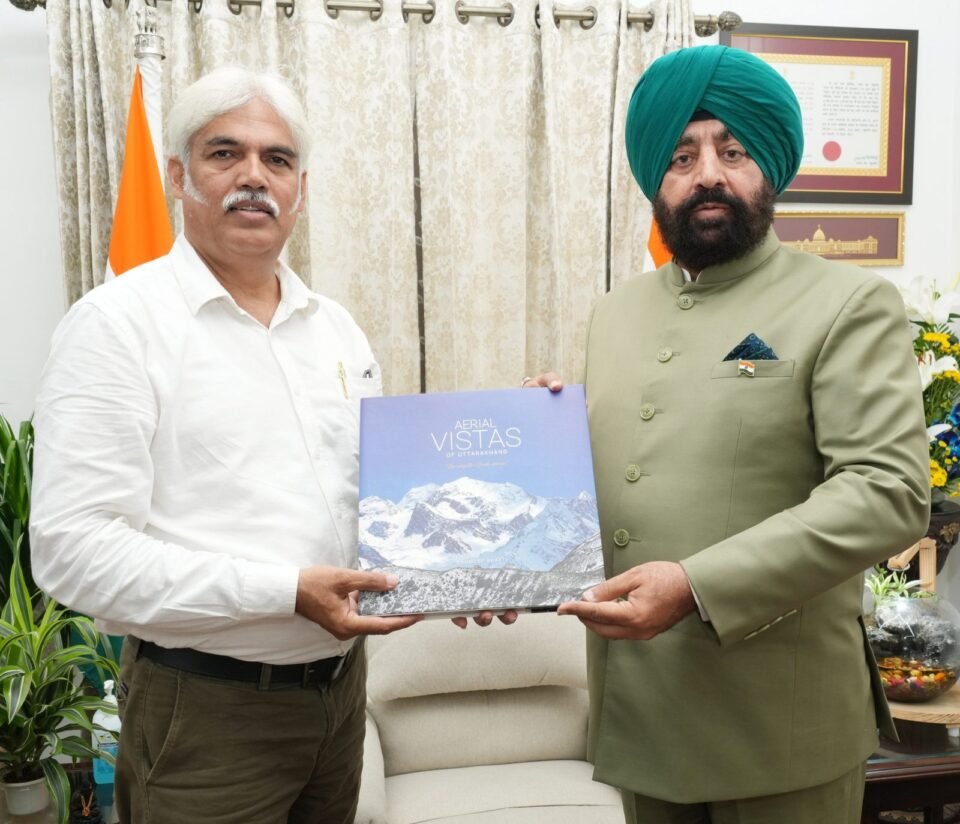 Photographer Bhumesh Bharti met the Governor and presented him the coffee table book 'Aerial Vistas of Uttarakhand'