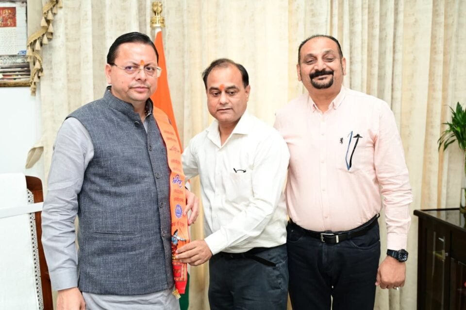 A delegation from the Holkar Education Trust met with Chief Minister Pushkar Singh Dhami and extended an invitation to the